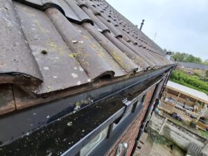 Angled view of gutter thoroughly cleaned out.