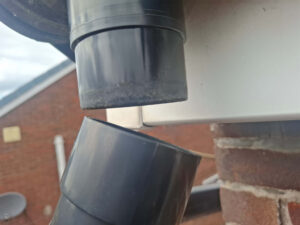 View of downspout detached half way down.
