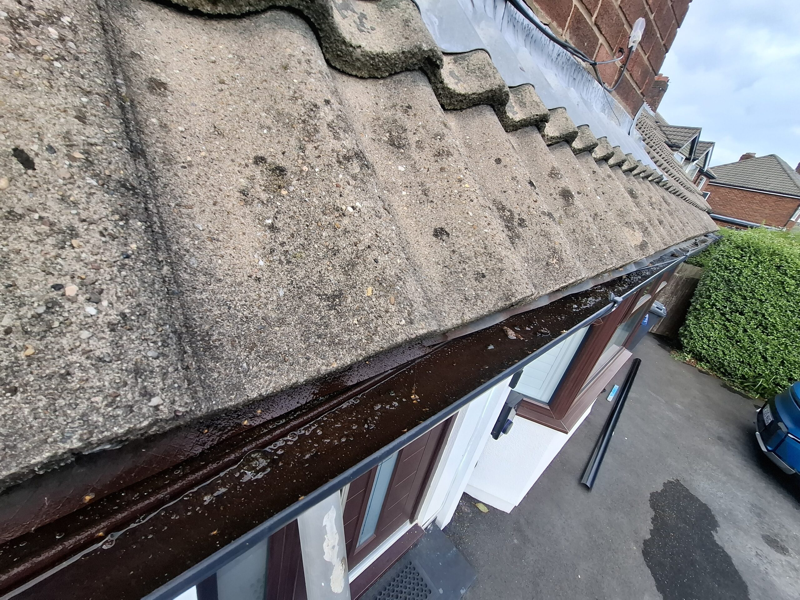 Wide angle view showing blocked guttering at Penwortham property.
