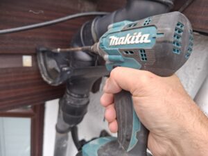 Close up of Makita drill being used to attach new guttering to Penwortham property.