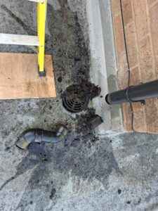 View of silt flushed out of downspout in Inskip property.
