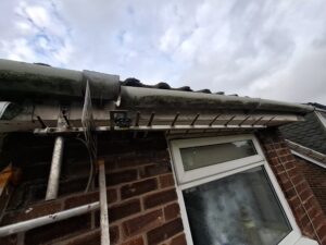 Underneath of broken gutter on end terrace property in Houghton.