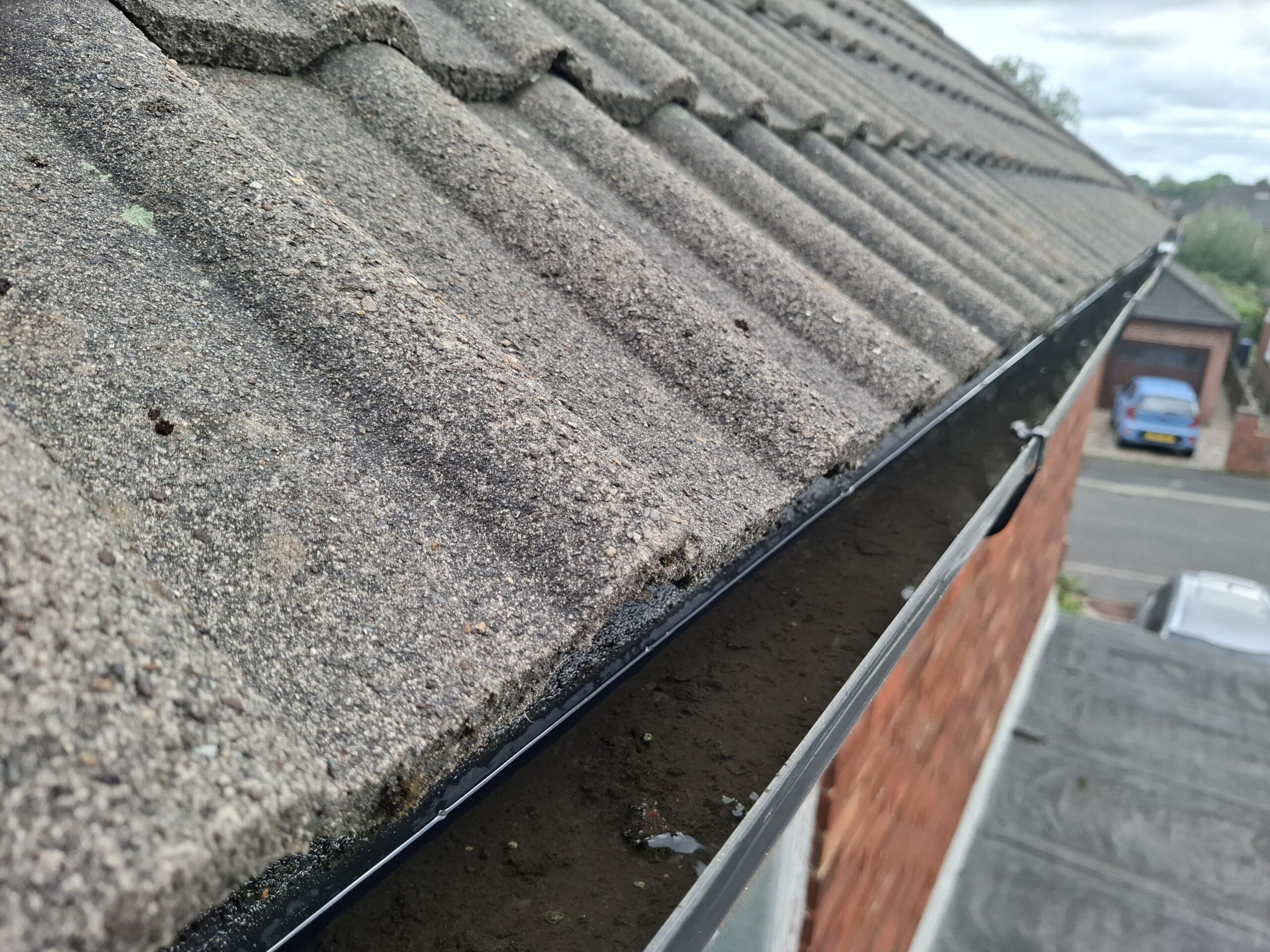 Guttering overflowing with water.