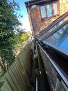 Wide angle view down side of property looking above cleaned conservatory guttering Fulwood.